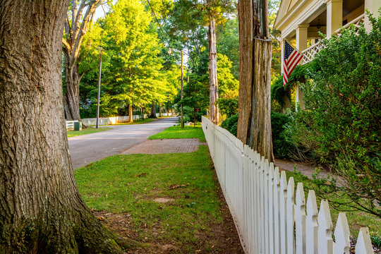 Look At Rural Small Town America With A White Picket Fence And Trees