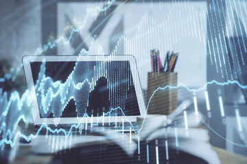 Stock market chart hologram drawn on personal computer background. Double exposure. Concept of investment.