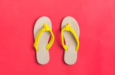 Eco yellow bamboo flip flops on red background Flat lay, top view. Zero waste, plastic free, holiday, summer, vacation concept. 