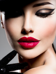 Сlose-up portrait of a woman  with red lips and fashion style make-up