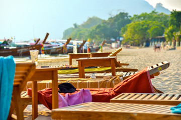 Fototapeta na wymiar Beach with sunbed at tropical beach. Relax deck chair vacation.