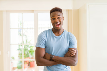 Handsome african young man smiling cheerful with crossed arms