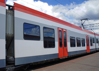 Red train carriage at the railway station.