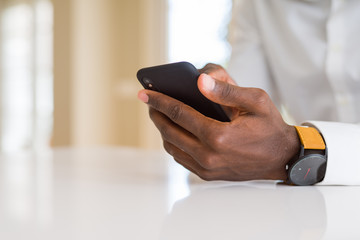 Close up of african man hands using smarpthone