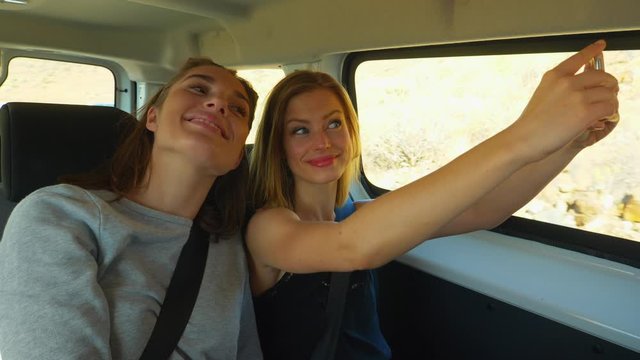 Pretty Female Models on a Vacation Taking Selfies on a Moving Van