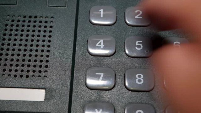Finger Dials The Number On The Button A Wired Phone.
