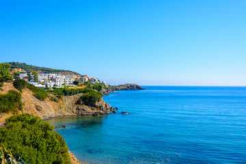Seascape. Greek village on a rocky shore. morning. clear blue water