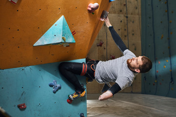 Physically handicapped sportsman starts his rock climbing training in the indoor settings, dreams...