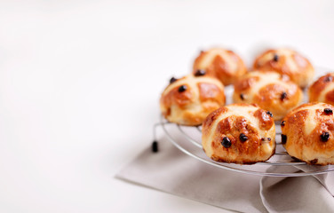 Buns marked with a cross and containing dried fruit, traditionally eaten during Lent.