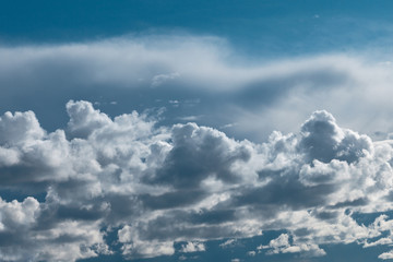 Dark thunderstorm and cirrus clouds in sky.