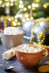 hot cocoa with marshmallows, cream and cookies on holiday christmas background