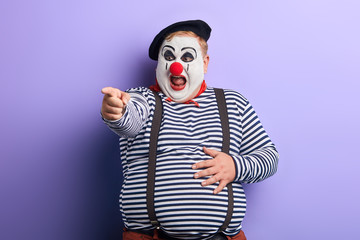 crazy artist indicates with finger , close up photo.isolated blue background, studio shot.feeling,...