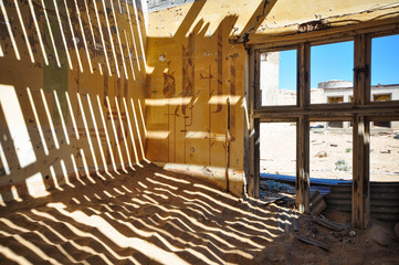 Fototapeta na wymiar Inside an abandoned house in the mining ghost town of Kolmanskop in Namibia