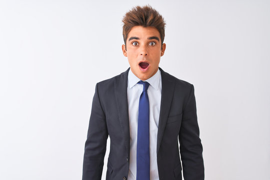Young handsome businessman wearing suit standing over isolated white background afraid and shocked with surprise expression, fear and excited face.