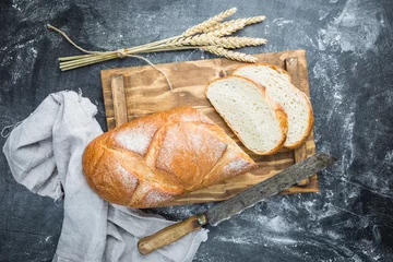 Tuinposter Fresh homemade crisp bread, top view. French bread. Bread at leaven. Unleavened bread © petrrgoskov