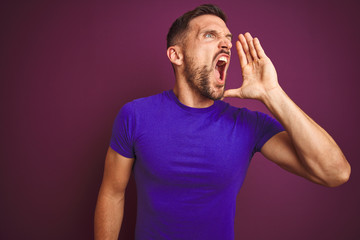 Young man wearing casual purple t-shirt over lilac isolated background shouting and screaming loud to side with hand on mouth. Communication concept.