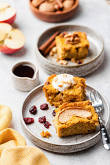 Sweet pumpkin cake with walnuts, cinnamon and dried cranberry cut in squares. Closeup view. Autumn comfort food