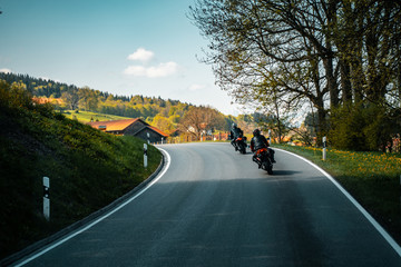 Two biker riding alone on mountainous road