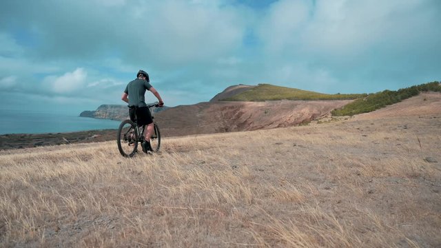 Tourist on bicycle enjoys the scenic view  while going for a ride