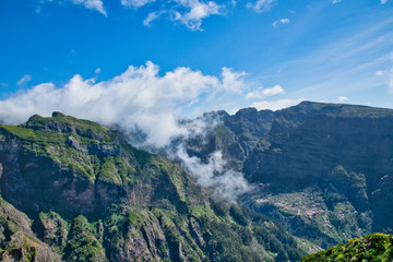 Obraz na płótnie Canvas View from the hiking trail at the Boca da Corrida belvedere on the Encumeada pass on Madeira Island, Portugal in summer, View to the village of Curral das Freiras 