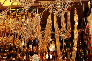 Gold jewellery hanging in a gold shop