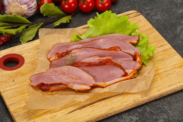 Sliced smoked duck breast served salad