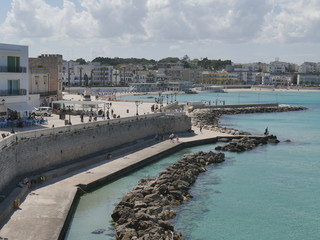 Otranto southern promenade along the walls. Otranto rocky and jagged beach and its southern...