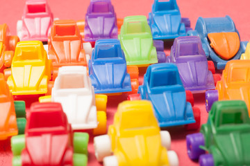 Fototapeta premium Toys plastic cars on a red background