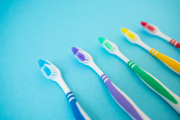 set of plastic toothbrushes on blue background