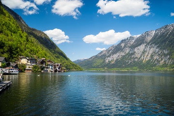 Village is located on the green slopes near lake.