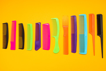 Plastic combs isolated on yellow background