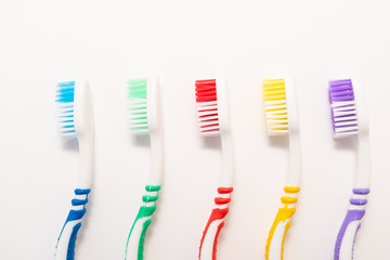 set of plastic toothbrushes on white background