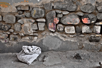 A sack with unknown content, dark grungy cul-de-sac.