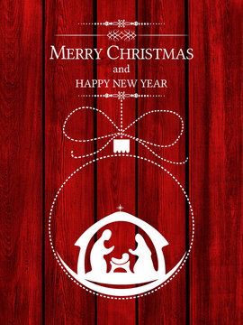 Christmas greeting card with Nativity scene in a ball above red wooden background