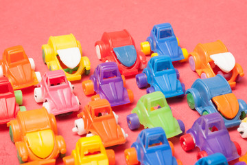 Toys plastic cars on a red background