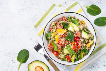 Quinoa salad with fresh vegetables on white.