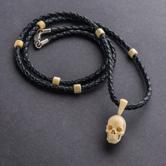 wood and silver jewelry in the shape of a skull