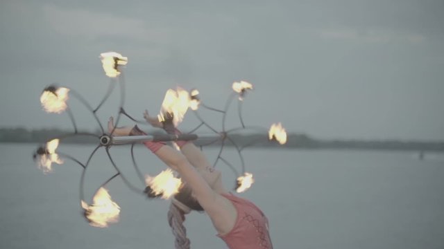 Girl with a torch fire show on the river bank at sunset. slow motion S-Log3, S-Gamut3, Cine