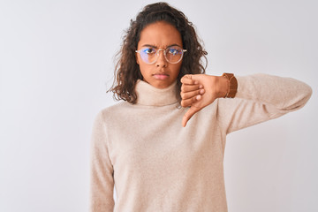 Young brazilian woman wearing turtleneck sweater and glasses over isolated white background with...