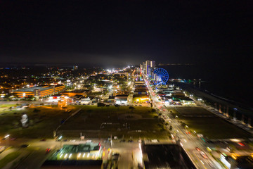 Fototapeta na wymiar Motion blur flying approach Myrtle Beach at night city lights