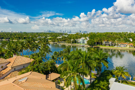 Upscale homes in Miami Beach waterfront with palm trees