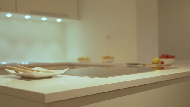 Modern kitchen interior design of the kitchen cabinets and modern kitchen countertop. Counter is made of the natural stone granite or quartz and cabinet doors are made of the natural wood.
