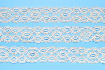 Beautiful white lace on light blue background.