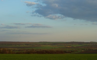 Middle aged white woman in medieval dress walks in the steppe
