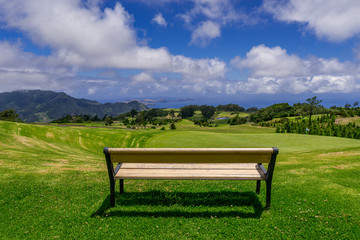 Park bench outdoor landscape. Wooden bench in golf course landscape. Mountain park bench panorama. Park bench relax