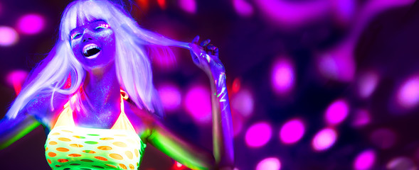 Neon Woman dancing. Fashion model woman in neon light, portrait of beautiful model with fluorescent make-up, Art design of female disco dancer posing in UV, colorful make up. On bright background