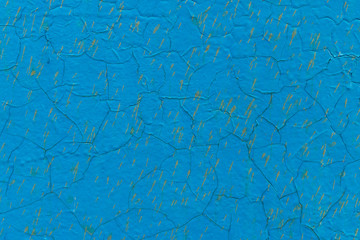 old rusty metal surface painted with peeling and cracked blue paint from time to time as an...