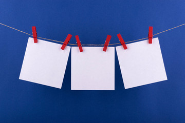 white sheets of notepad for notes and reminders of white color fastened with decorative red...