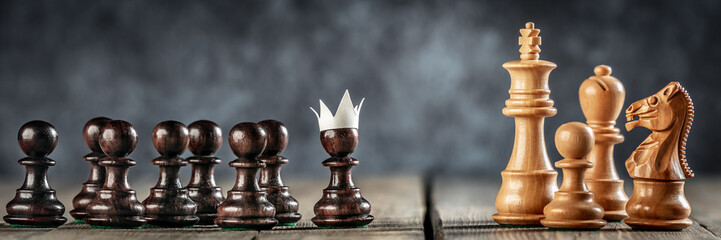 Fototapeta  Small Courageous Pawn With Fake Paper Crown Costume Leading Others Into Battle Against The Enemy - Business Entrepreneur / Leadership Concept   obraz