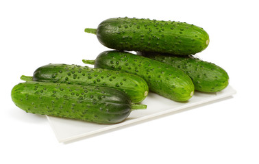 Cucumbers on plate on white background, isolated